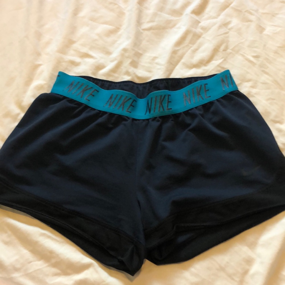 Dark blue Nike shorts, with light blue Nike rim.